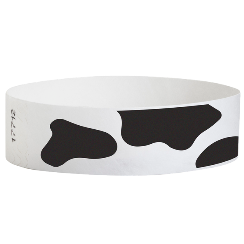 white tyvek wristband with cow pattern in black - round version shown