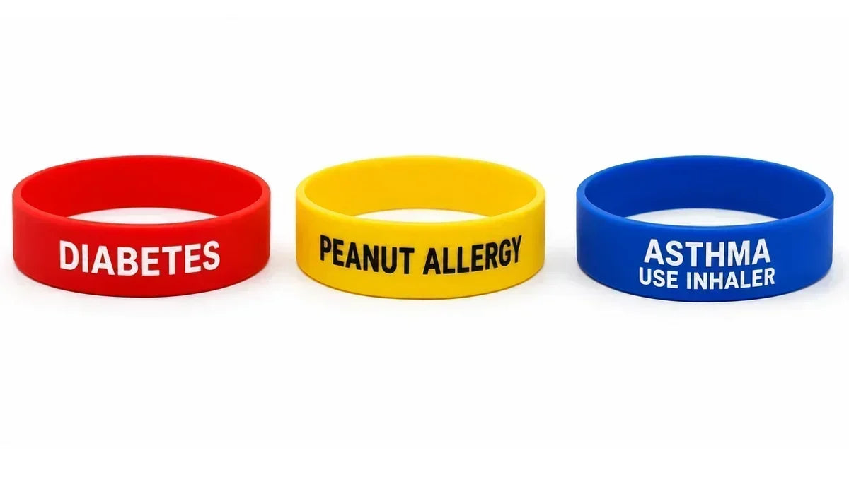 Silicone medical alert wristbands for diabetes, peanut allergy, and asthma displayed on a white background.