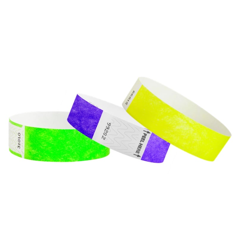 tyvek 3/4" solid wristbands showing qwik fit neon green, litter free purple and solid neon yellow