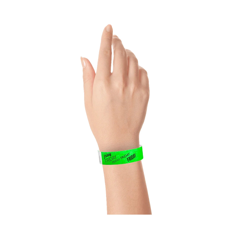 hand wearing neon green tyvek wristband with friday  text in black ink repeated