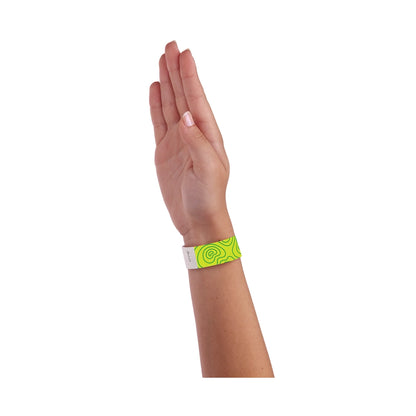 hand wearing lime green tyvek wristband with kelly green topographical map design