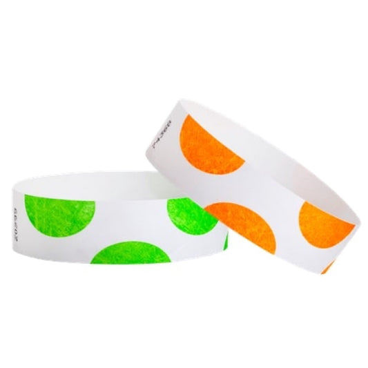 white tyvek wristbands with a half circle pattern all over the bands, shown in neon orange and neon green