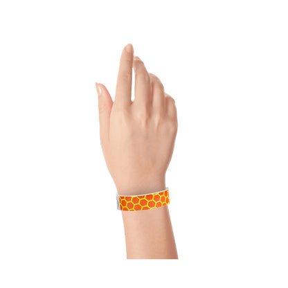 neon orange tyvek wristband with neon yellow honeycomb pattern - on hand 