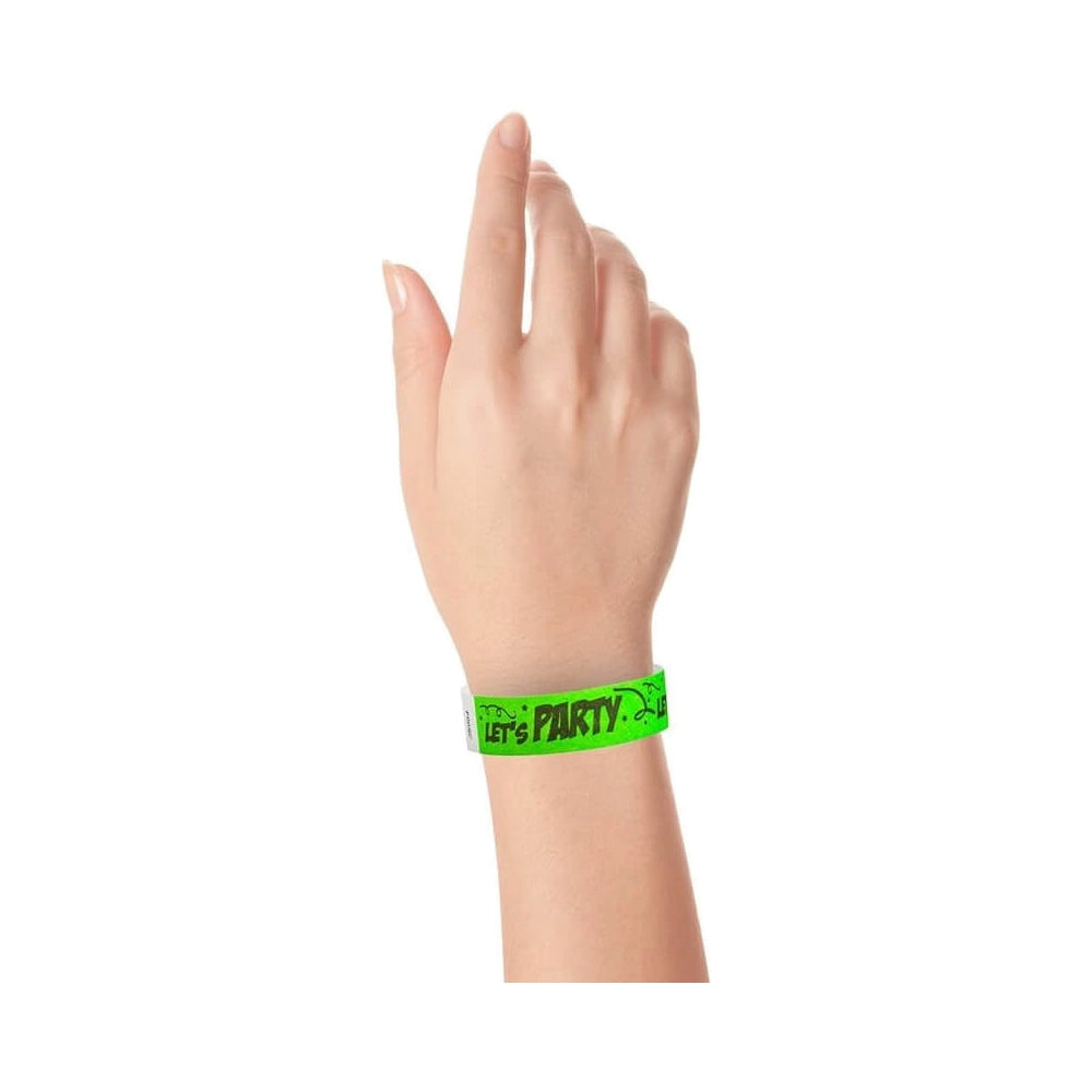 wrist wearing a neon green tyvek wristband with black lettering "Let's Party"