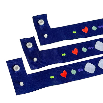 l shaped cloth wristband with snap closure in blue with heart pattern