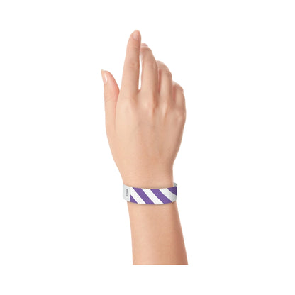 hand wearing white tyvek wristband with purple diagonal stripes