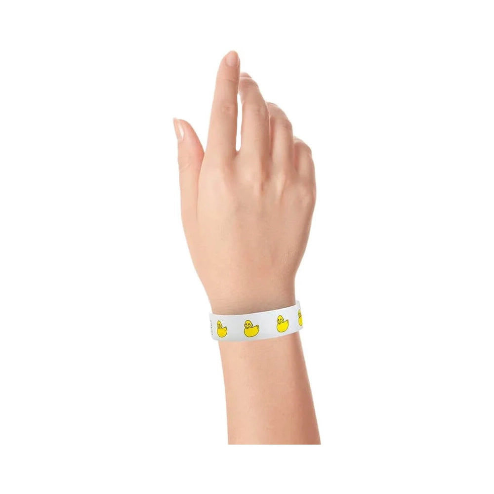 wrist wearing a white tyvek wristband with yellow rubber duckies repeating