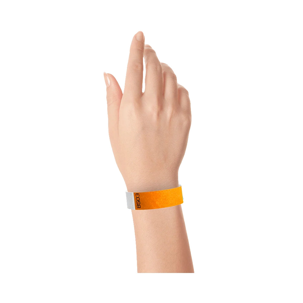 Hand wearing duplicate number in neon orange tyvek 3/4" wristbands