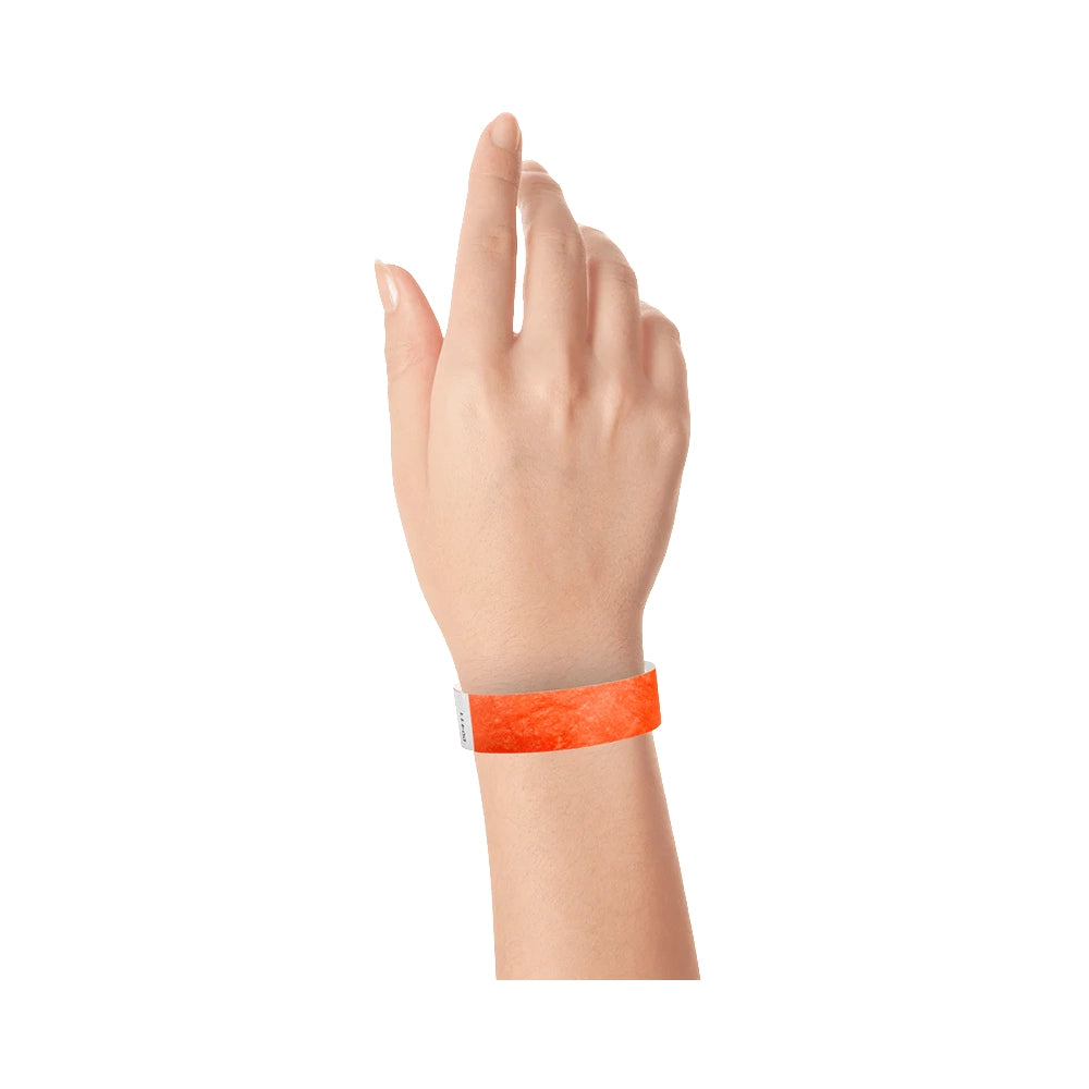 Coral red tyvek wristband on wrist 
