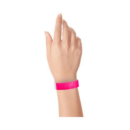 Neon pink tyvek wristband on wrist 