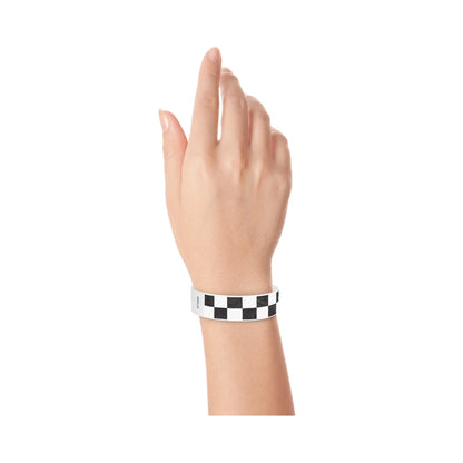 Hand wearing a black and white checkered wristband 