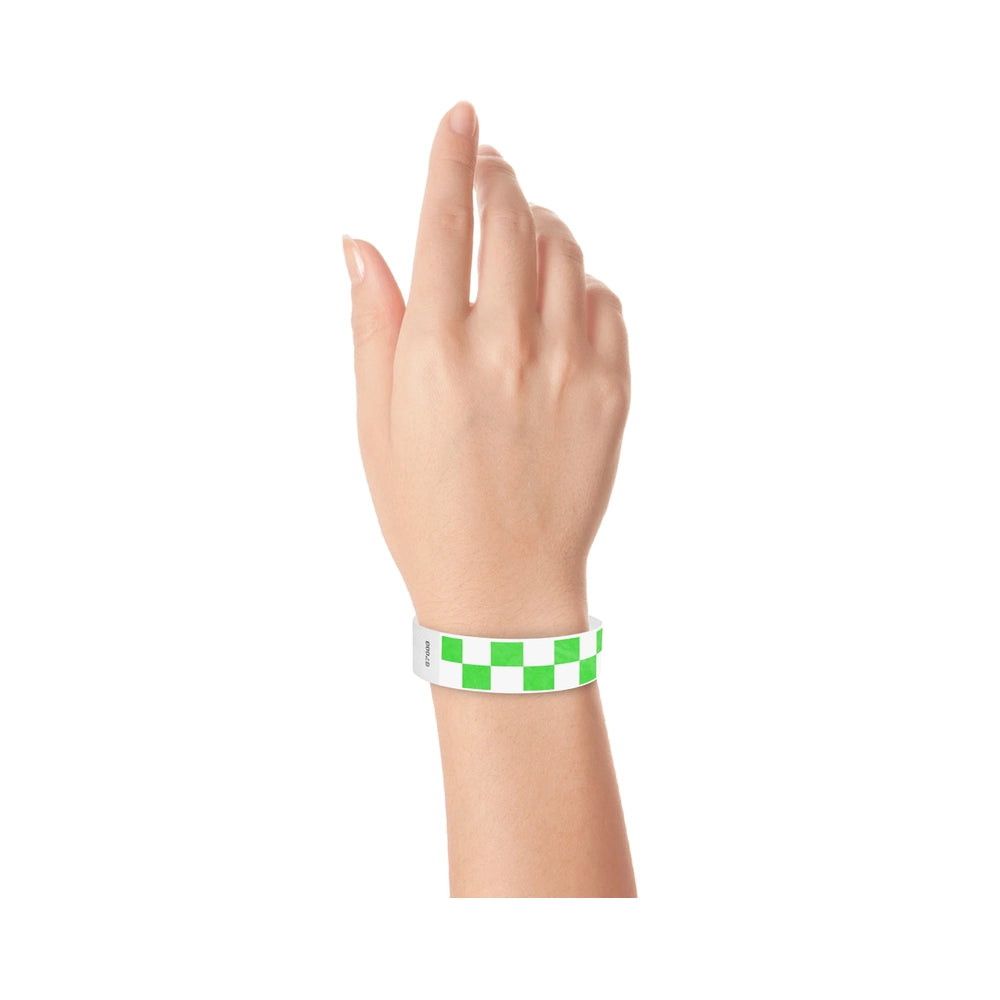 Hand wearing a neon green and white checkered wristband 