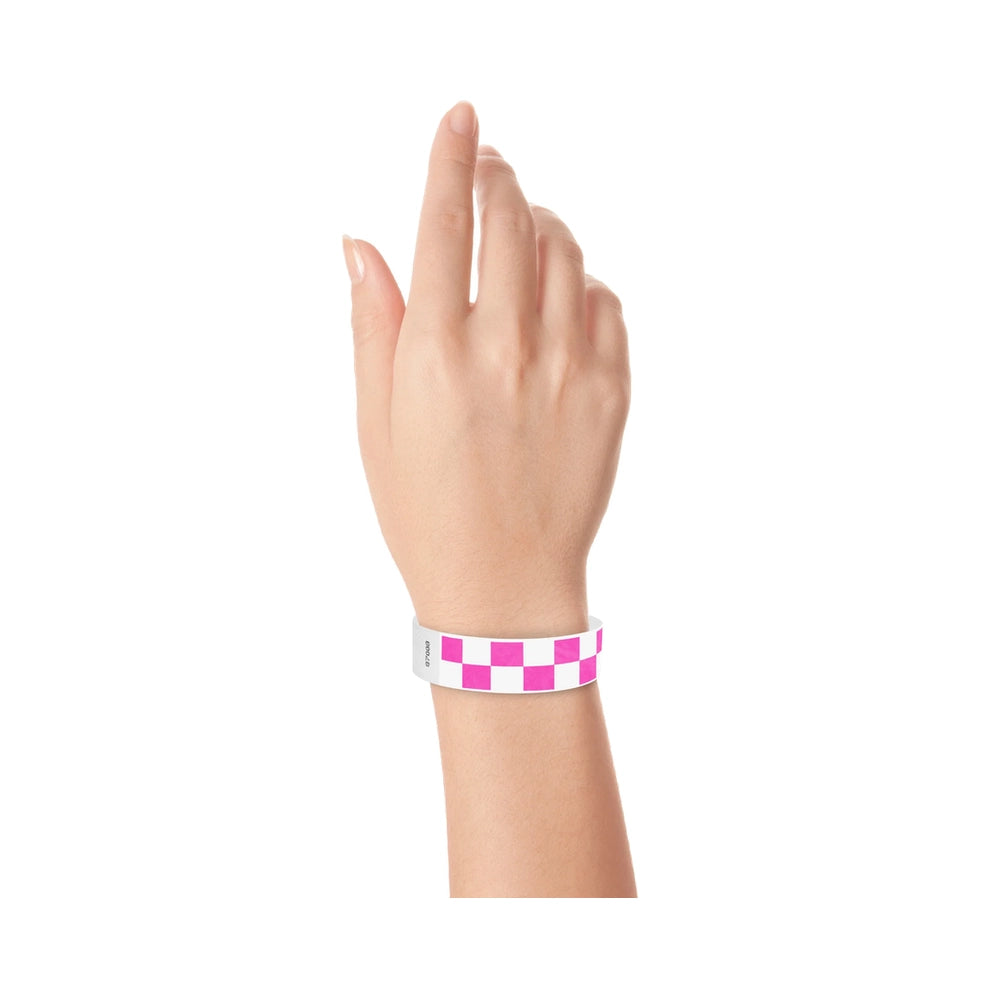 Hand wearing a neon pink and white checkered wristband 
