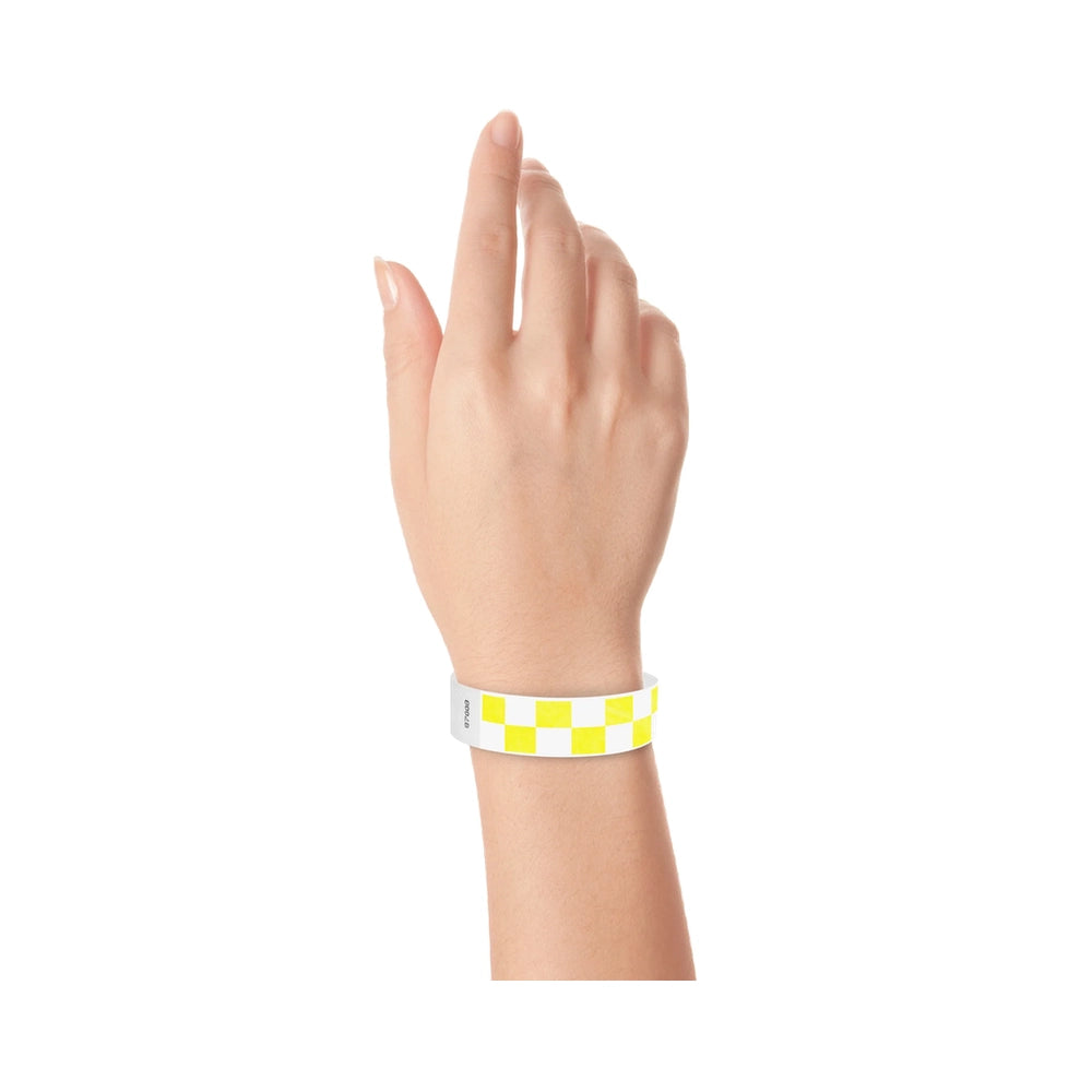 Hand wearing a neon yellow and white checkered wristband 