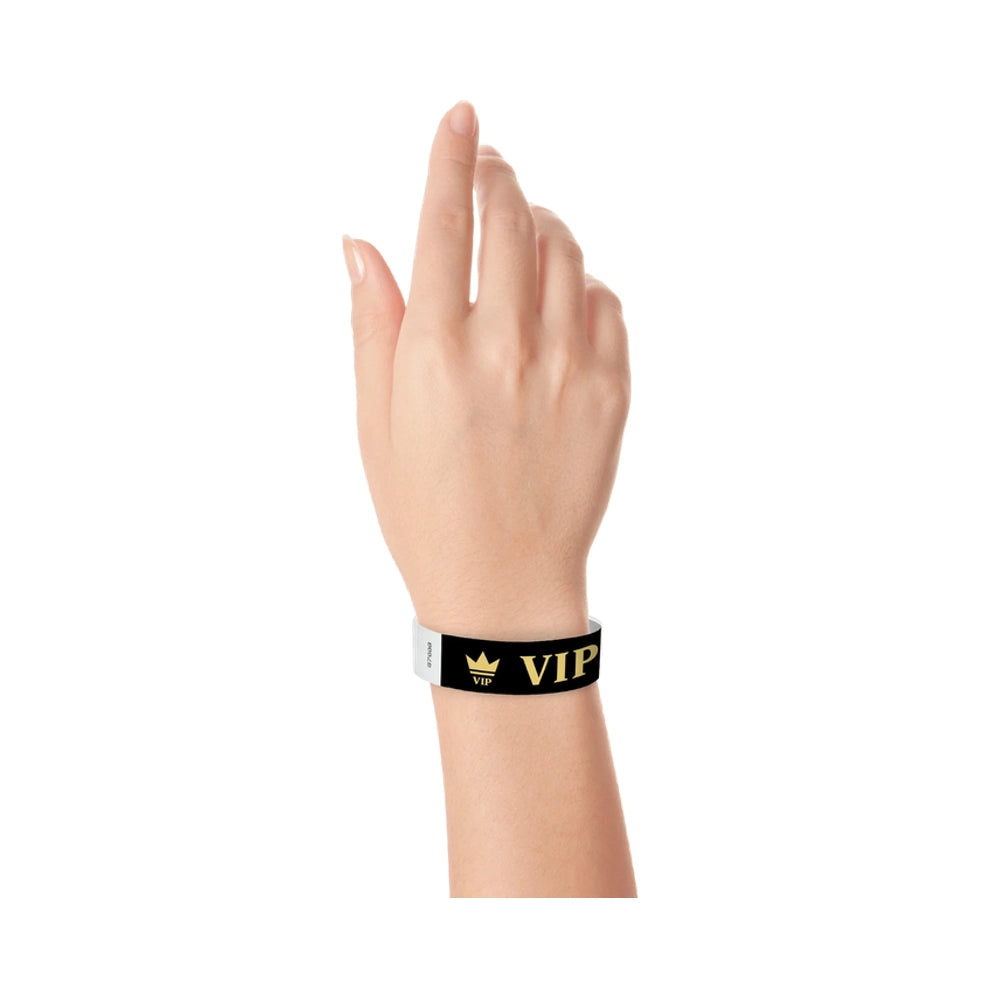 hand wearing Black wristband with text "VIP" and a crown printed in gold 