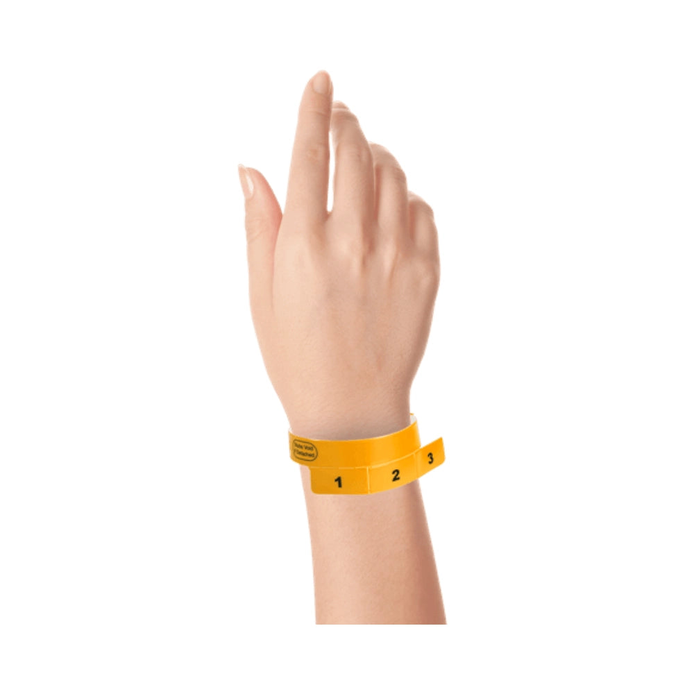vinyl wristband with 3 tab in neon orange - shown on wrist 
