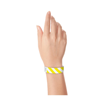 hand wearing white tyvek wristband with neon yellow diagonal stripes