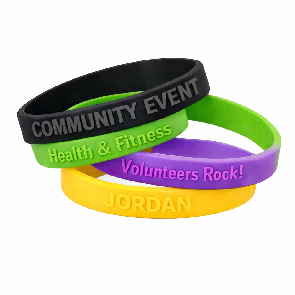 embossed silicone wristand example customizations in black, green, purple and yellow