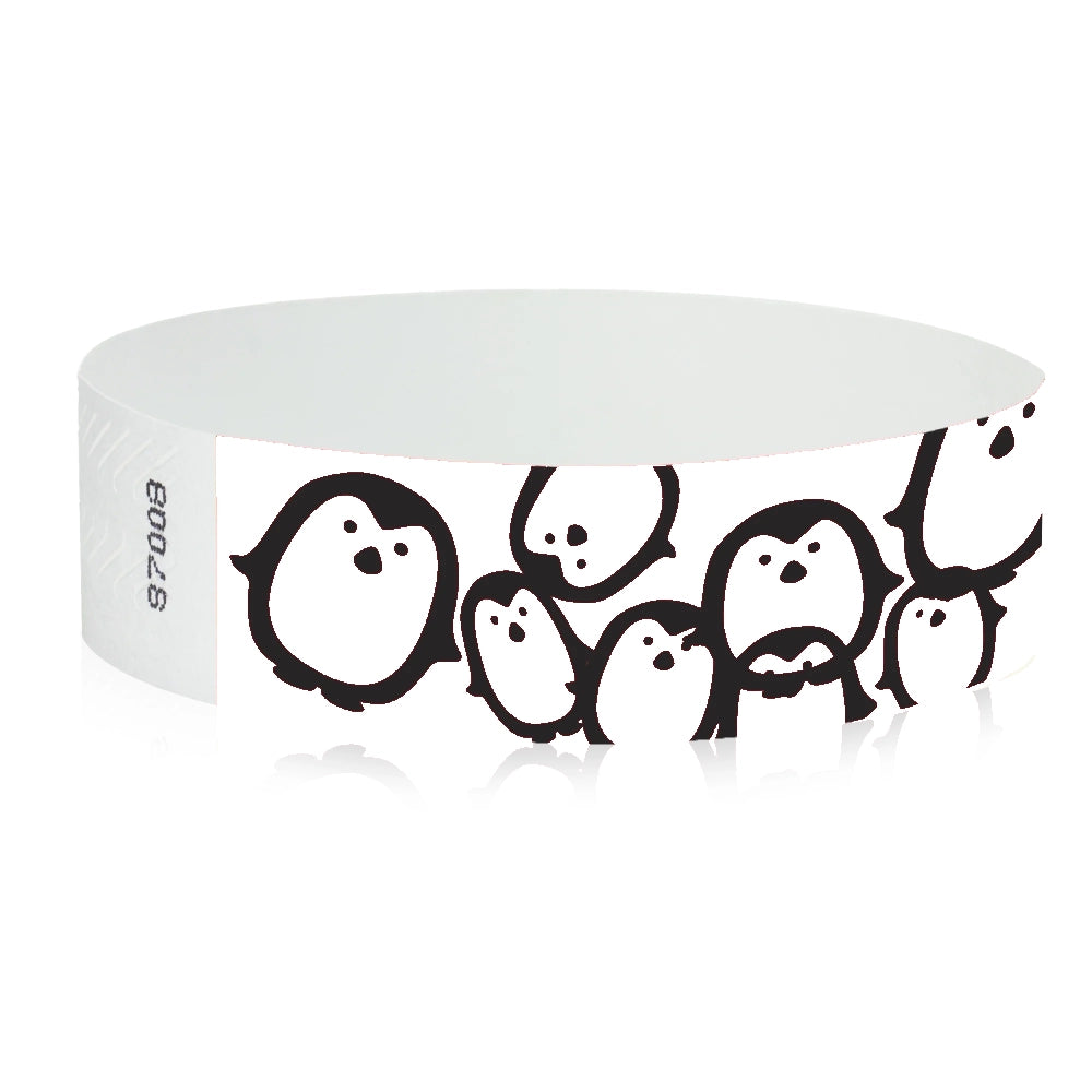 neon blue Tyvek Wristband with black penguins - round version shown