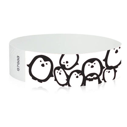 neon blue Tyvek Wristband with black penguins - round version shown