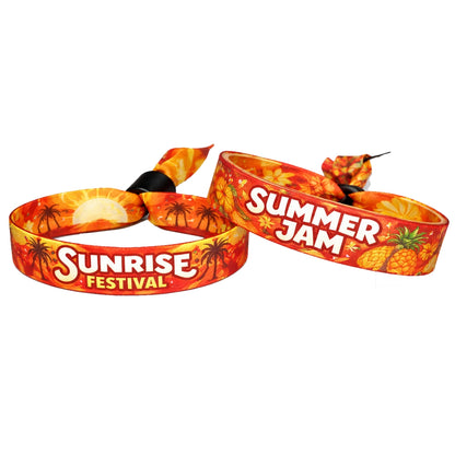 Two colorful polyester sublimation cloth wristbands with 'Sunrise Festival' and 'Summer Jam' text on orange/red/yellow pattern