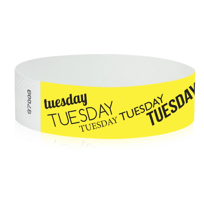 neon yellow tyvek wristband with tuesday text in black ink - round version shown