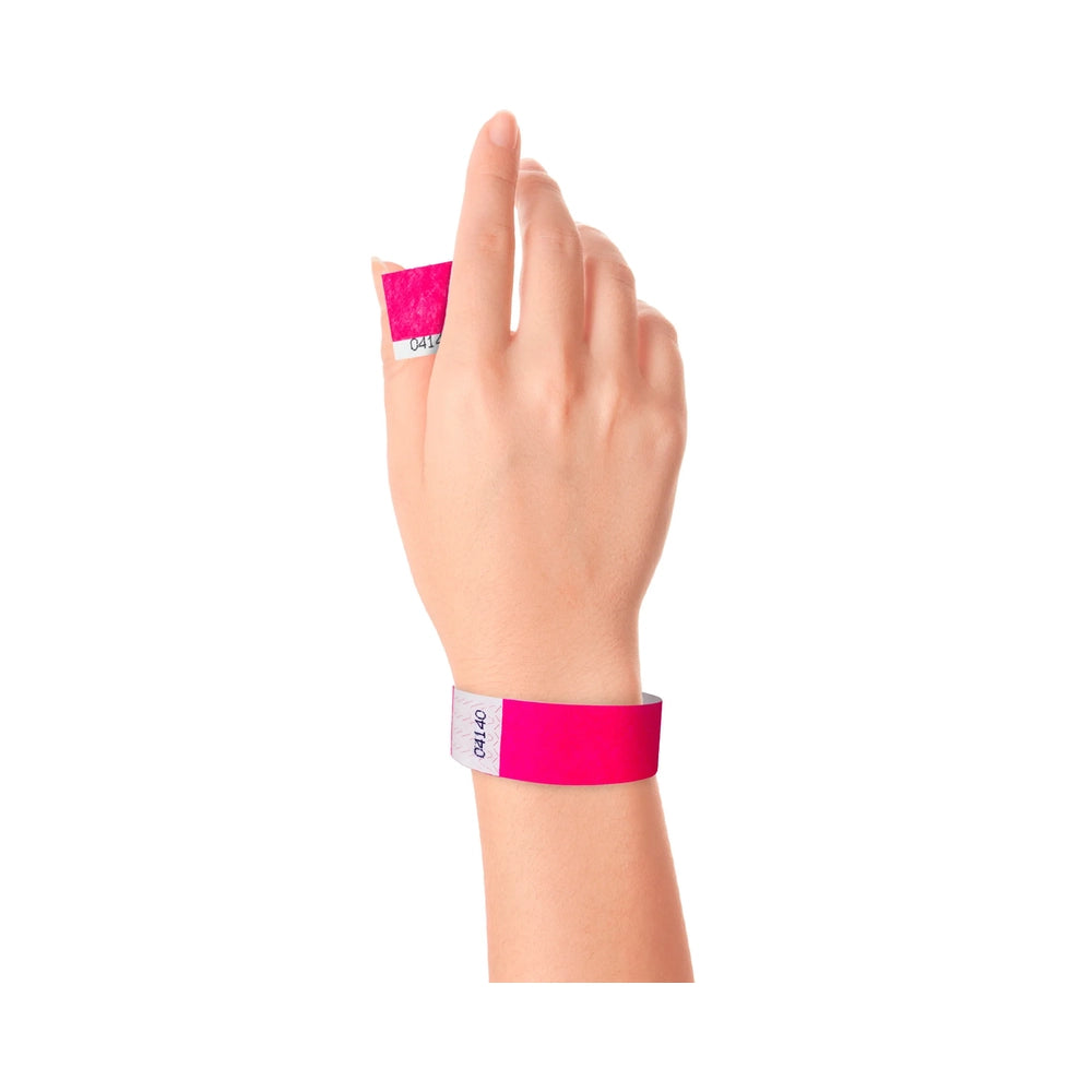 Wrist wearing Tyvek 1" stub wristband in neon pink
