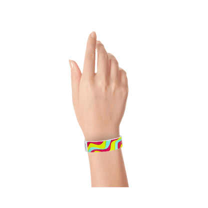 tyvek 3/4" wristband in neon red, neon yellow and aqua groovy stripe pattern shown on wrist 